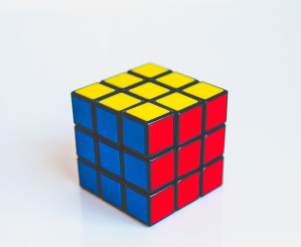 yellow, blue, and red 3x3 puzzle cube toy