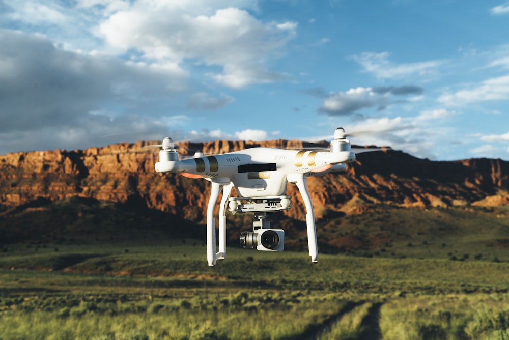 landscape photography of DJI Phantom flying midair in front of mountain