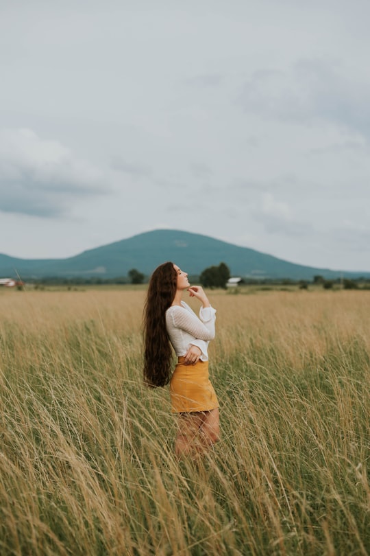 woman standing in the middle of grass field in Poteau United States