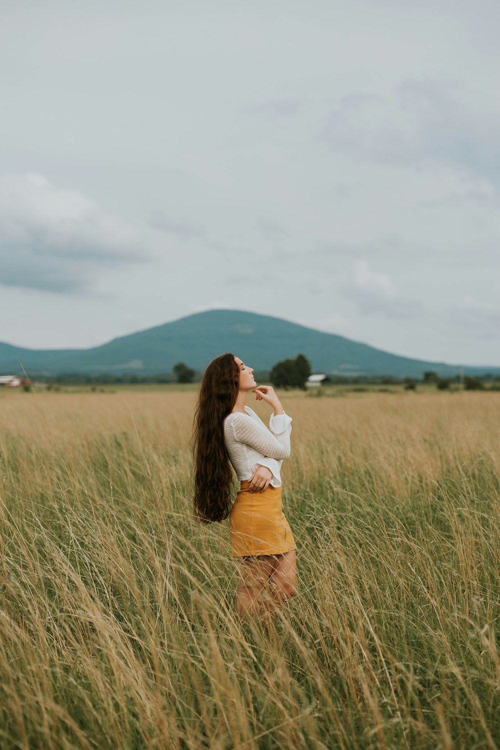 woman standing in the middle of grass field