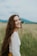woman smiling white standing on green grass field during daytime