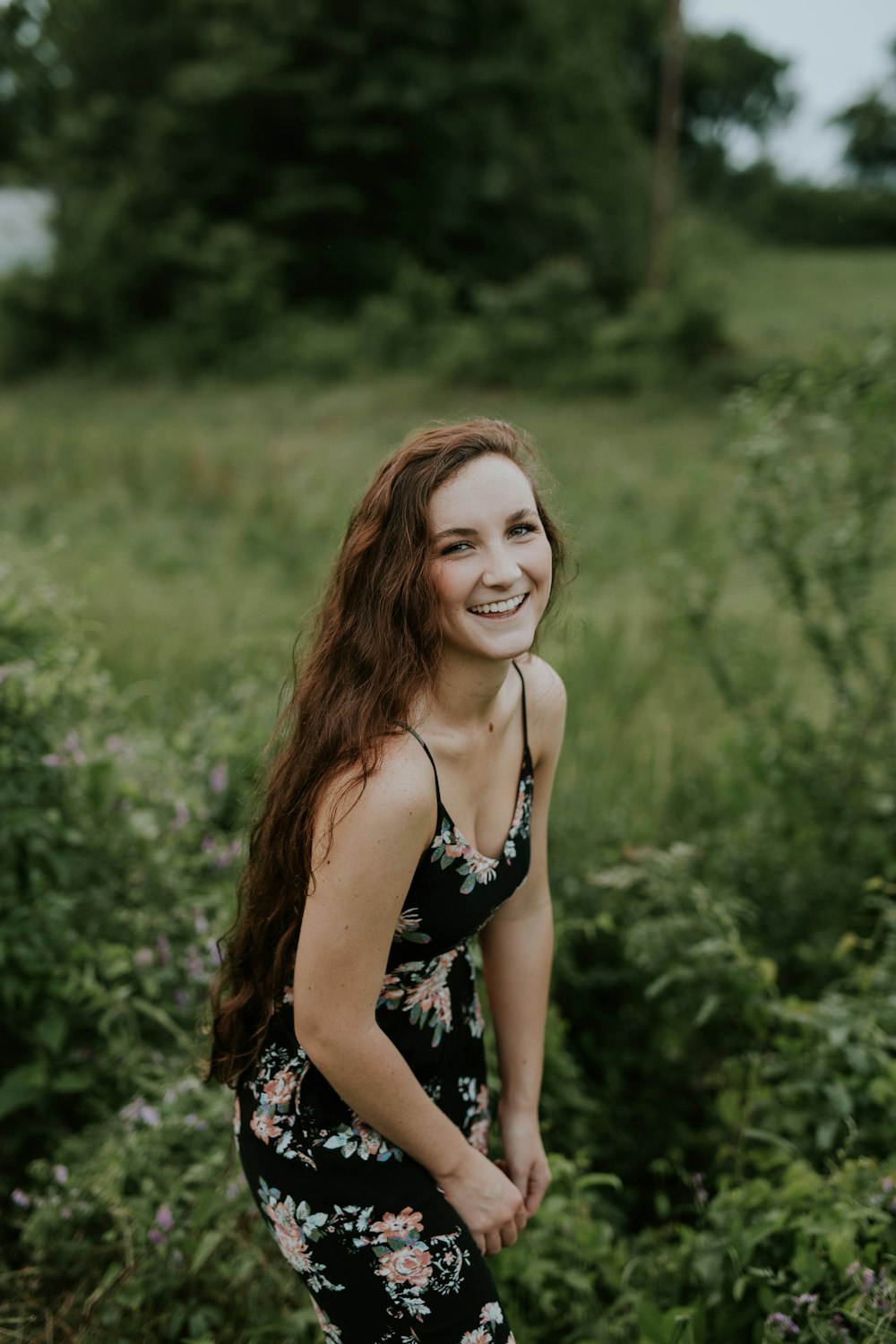 shallow focus photography of woman posing and smiling at camera