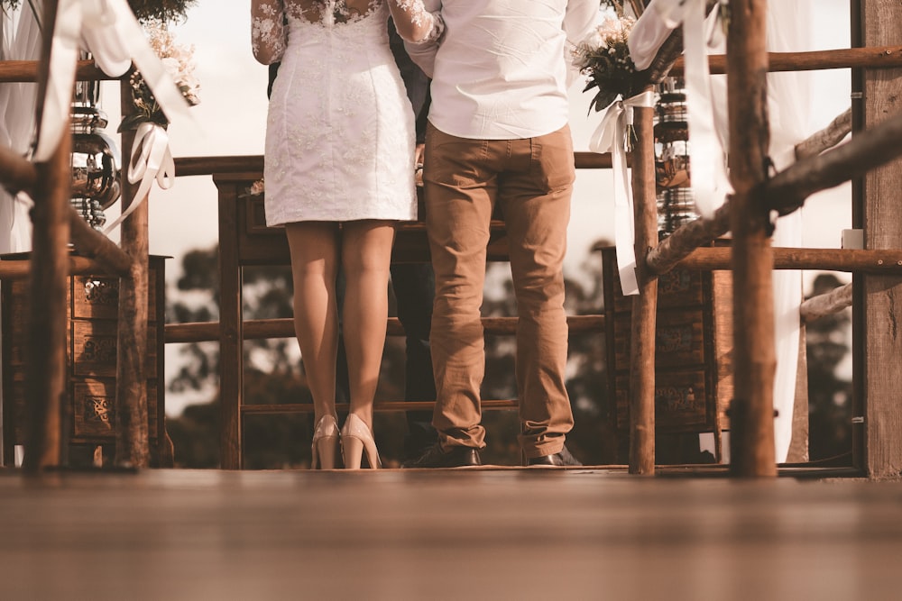 couple standing on front of brown table at daytime