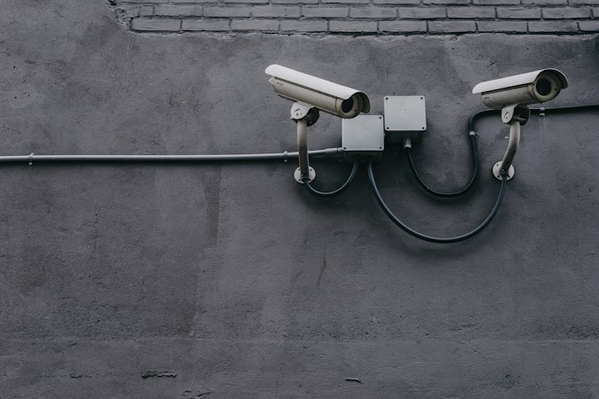 Two security cameras mounted on an exterior wall, a reminder of the safety tools schools across Clark County rely on