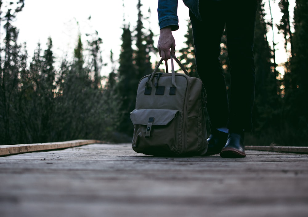 person standing on road while carrying backpack