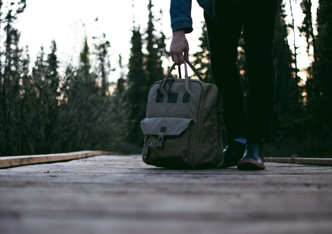 person standing on road while carrying backpack,