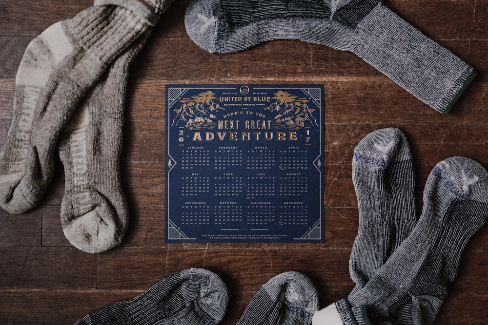 Paar graue Socken und blauer Kalender auf dem Tisch