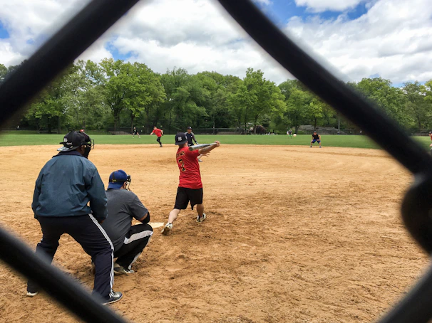 Veterans playing friendly softball on a bright, clear day.