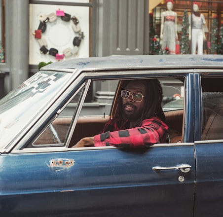 man driving blue car