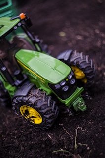 Close-up of a green tractor wheel with the Libyan landscape in the background.