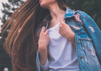 woman holding her white shirt flipping hair