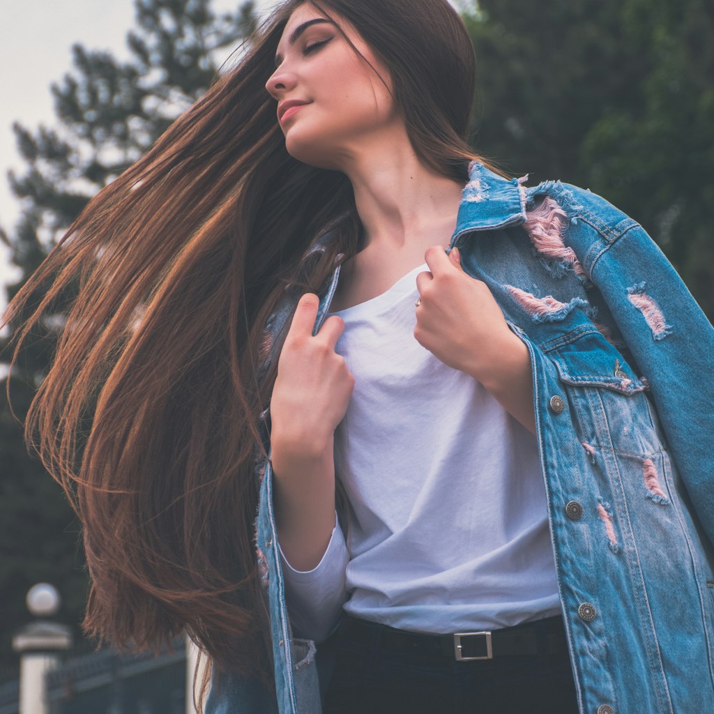 woman holding her white shirt flipping hair