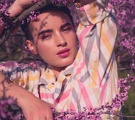 model woman taking photo on purple tree at daytime