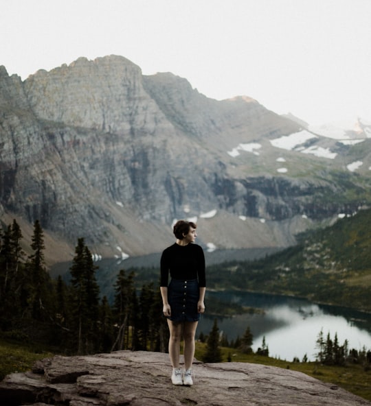 man on top of hill in Glacier National Park United States