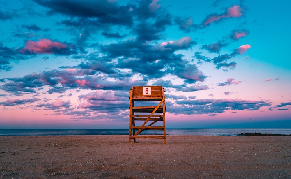 brown wooden stand on shore under gray sky