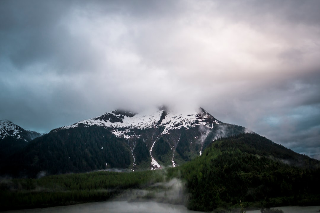 snow-capped mountain under gray sky