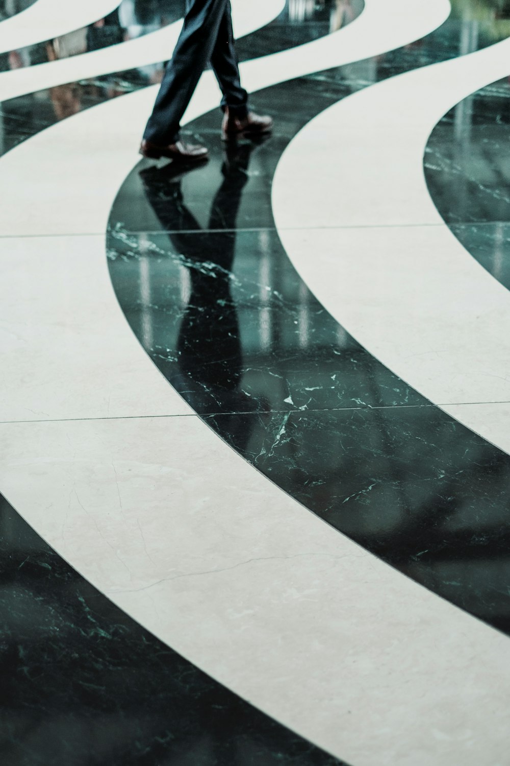 Swirling black and white pattern on a marble floor