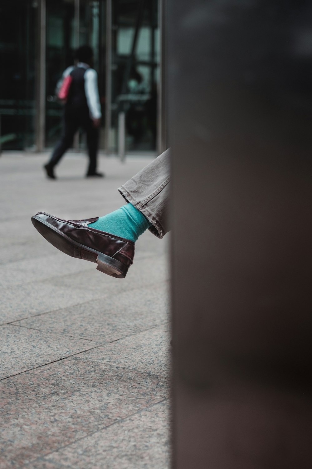 person showing unpaired brown leather dress shoe