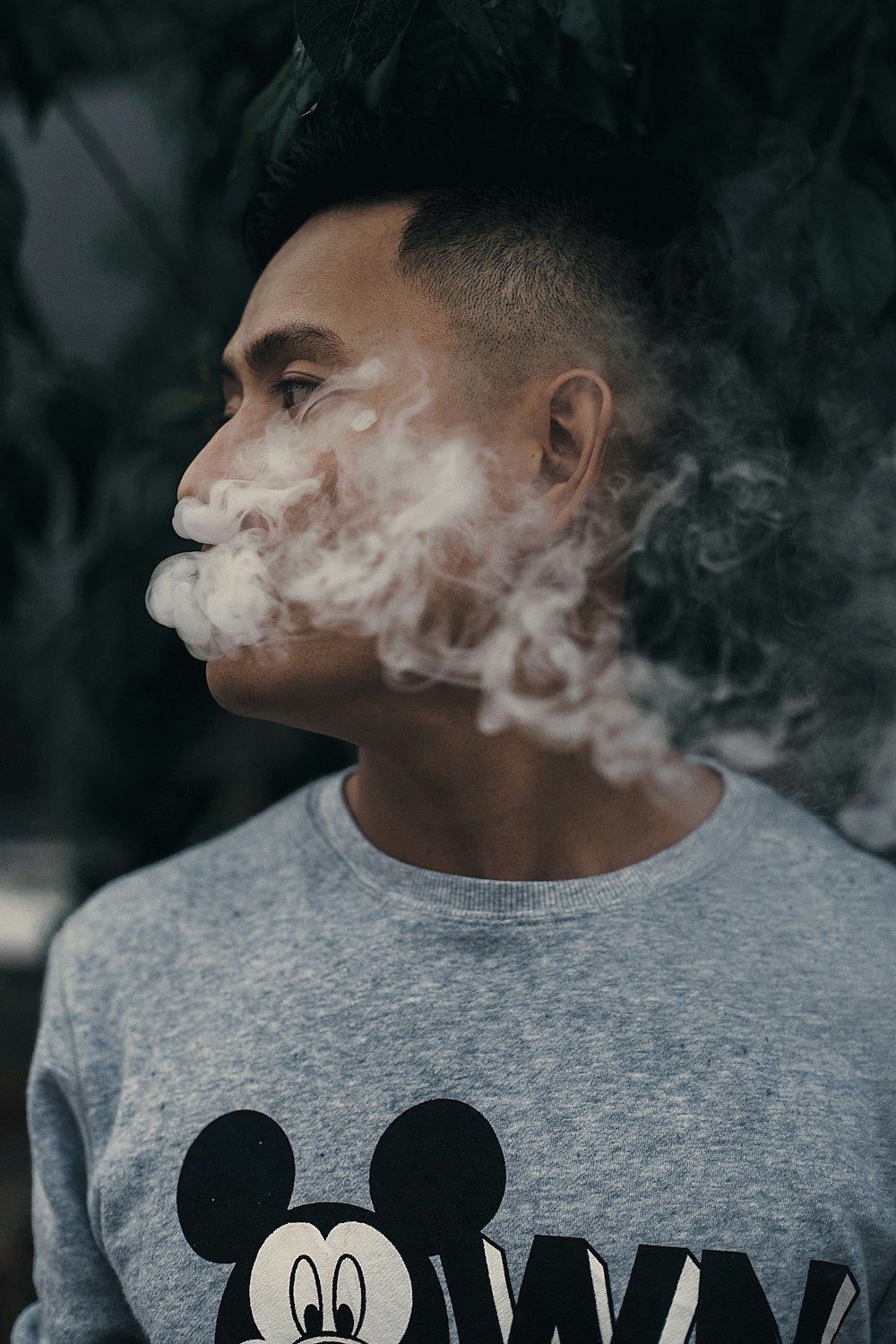 man smoking while looking right