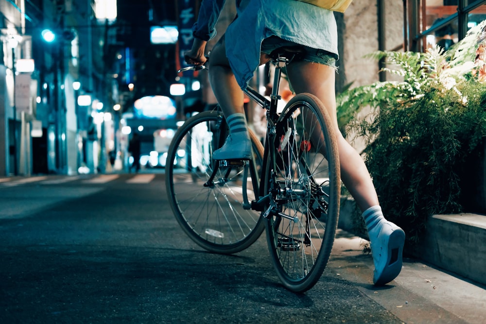 person riding on black bicycle