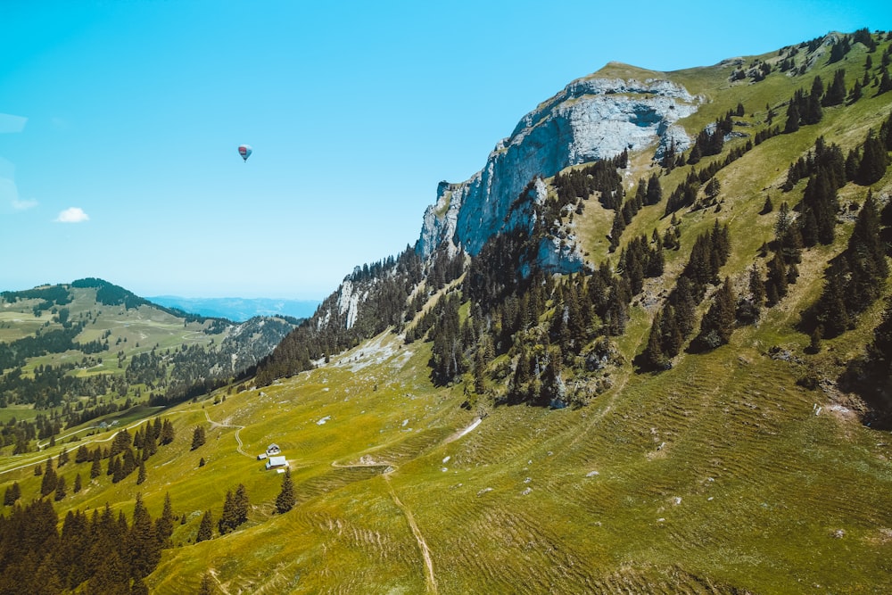 green mountains and trees under blue clear sunny sky