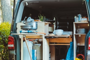 Close-up of a custom trailer’s stainless steel kitchen interior with modern appliances.