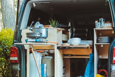 Close-up of a propane stove and diesel heater setup in a cozy caravan kitchen.