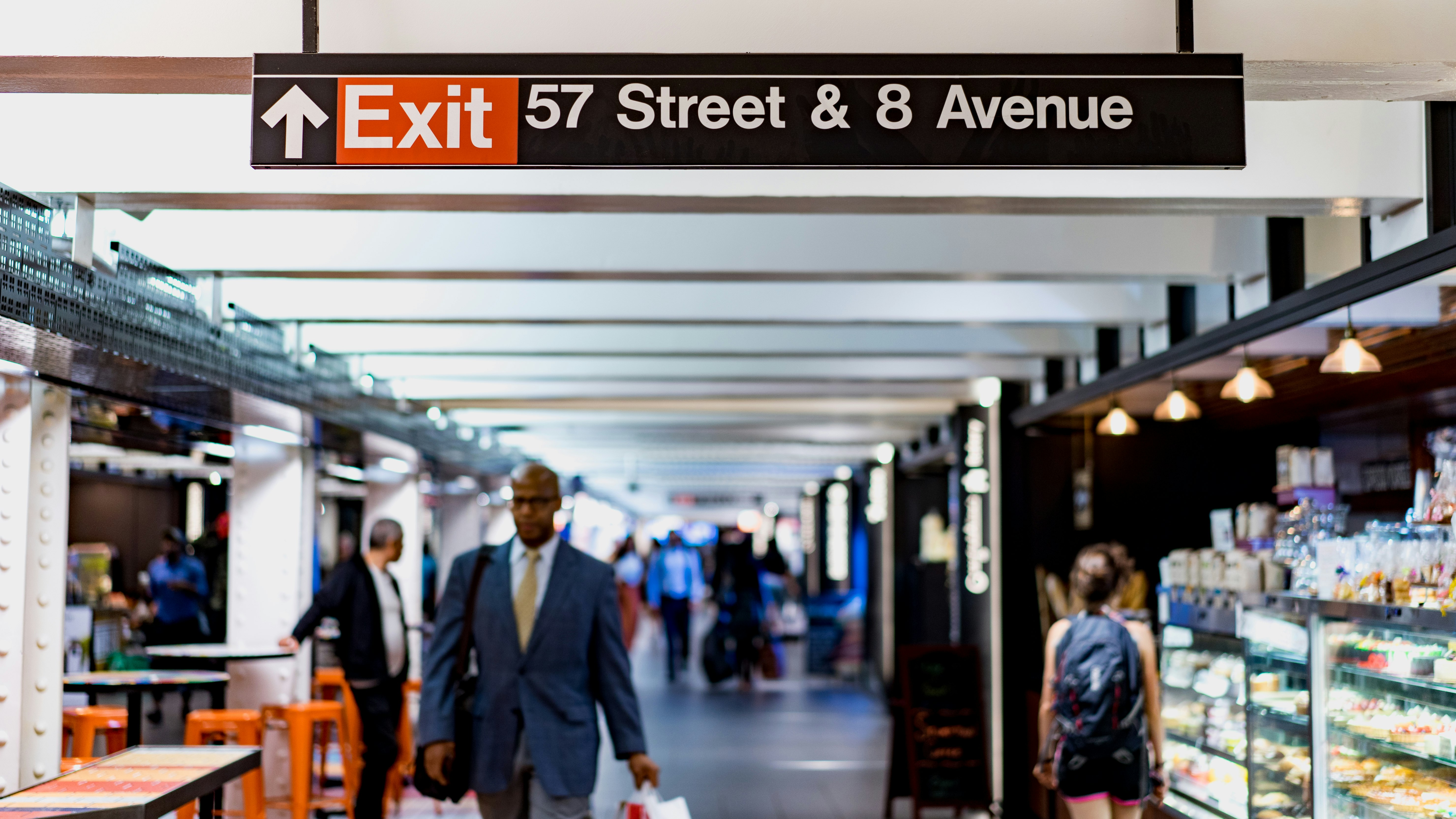 shallow focus photography of man walking under 57 Street & 8 Avenue tunnel