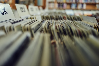 Rows of vinyl records sorted and organized in crates with labels, in what appears to be a record store or a dedicated music section of a store.