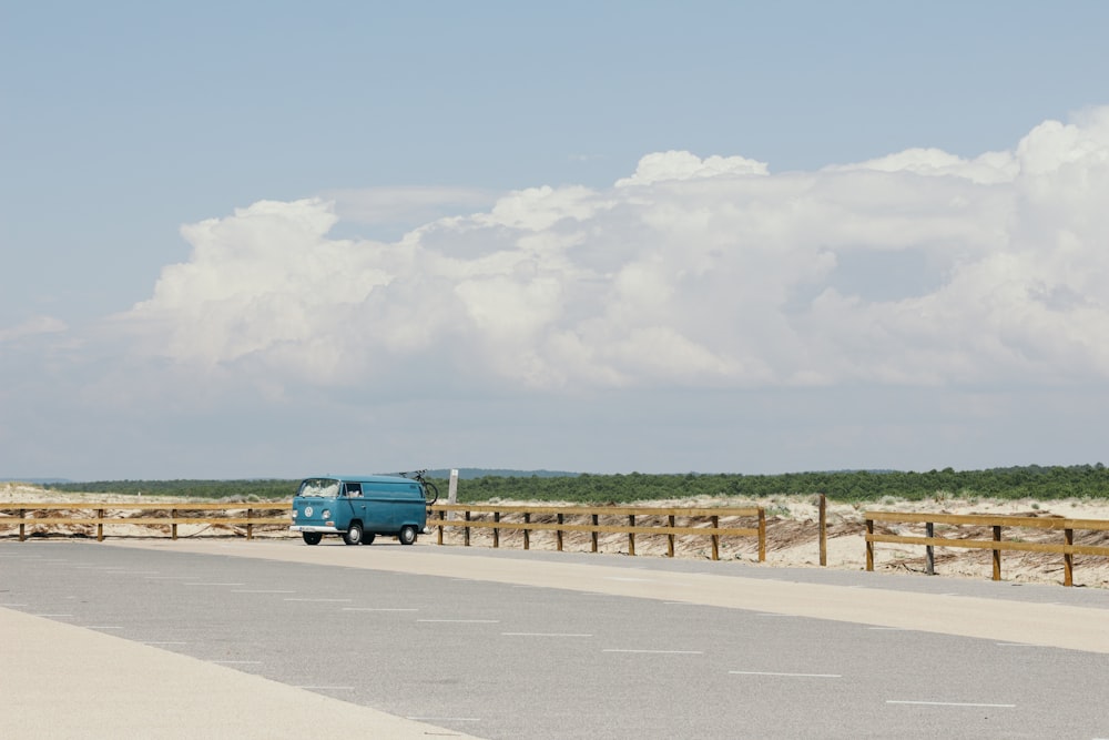 blue van on gray concrete road top