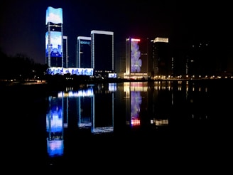 A captivating nighttime cityscape under a deep blue sky, reflecting the brand's signature color.