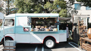 Finished food service truck parked outside the shop, showcasing clean paintwork and serving windows.