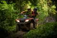 man and woman riding on ATV