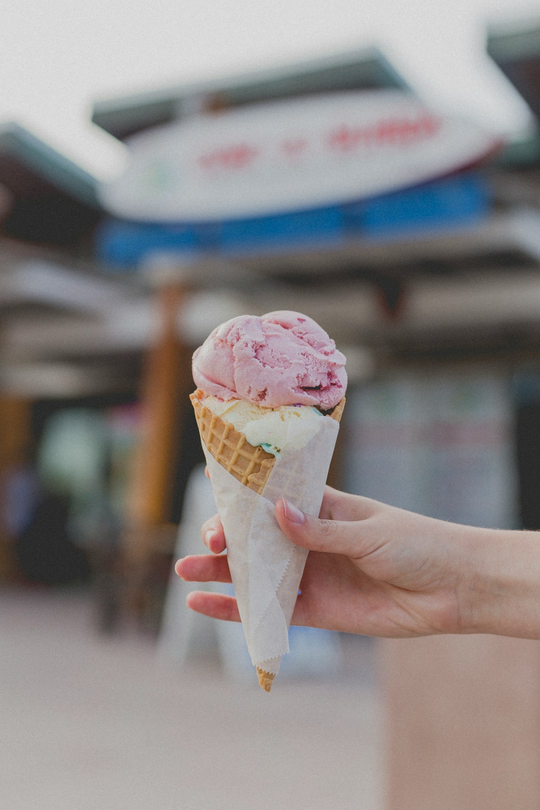 person holding strawberry ice cream