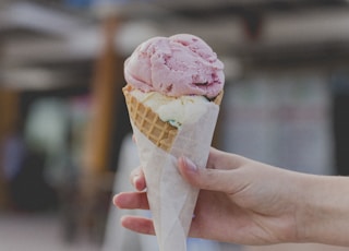 person holding strawberry ice cream