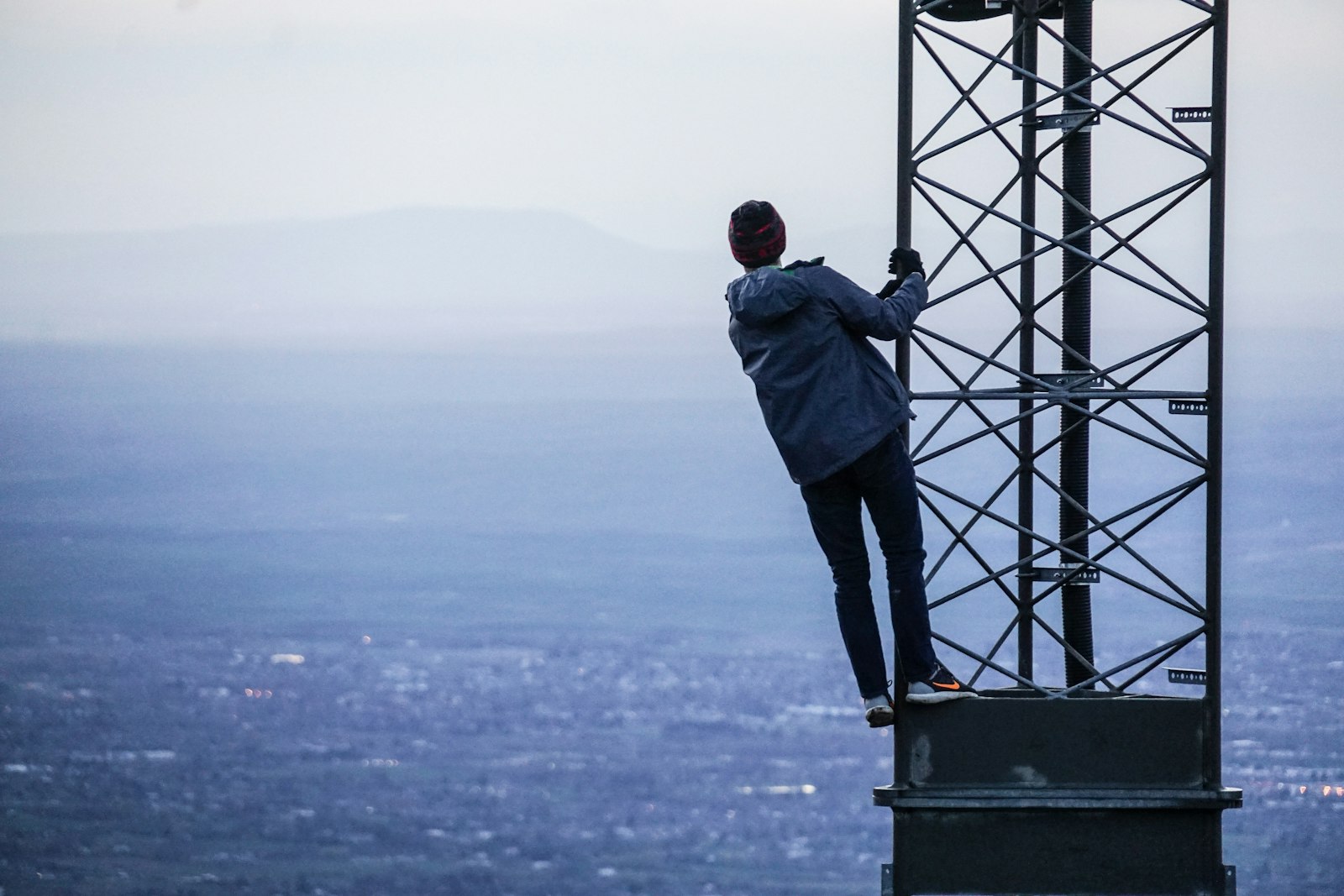 Sony E 18-200mm F3.5-6.3 OSS sample photo. Man climbing on tower photography