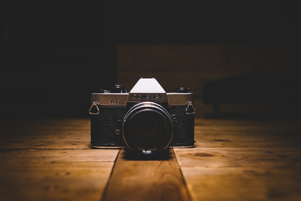 black and gray SLR camera on floor