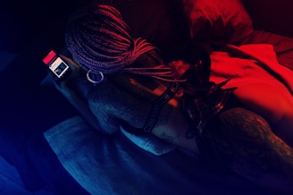woman lying on bed holding smartphone