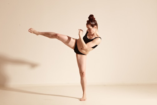 Close-up of a black belt performing a powerful taekwon-do kick.