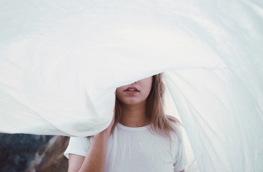  woman under white cloth sheet