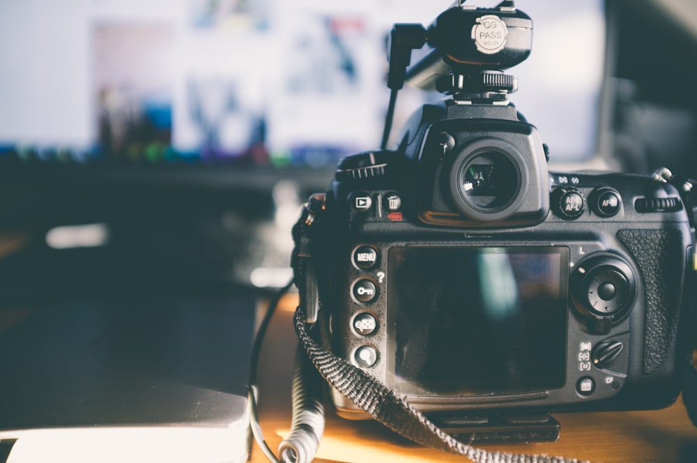 black nikon dslr camera on white table