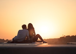 couple sitting near trees during golden hour hamer candy live