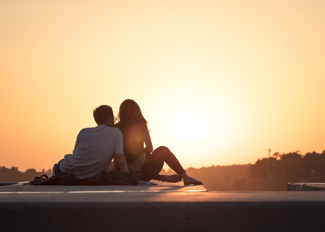 couple sitting near trees during golden hour, Love