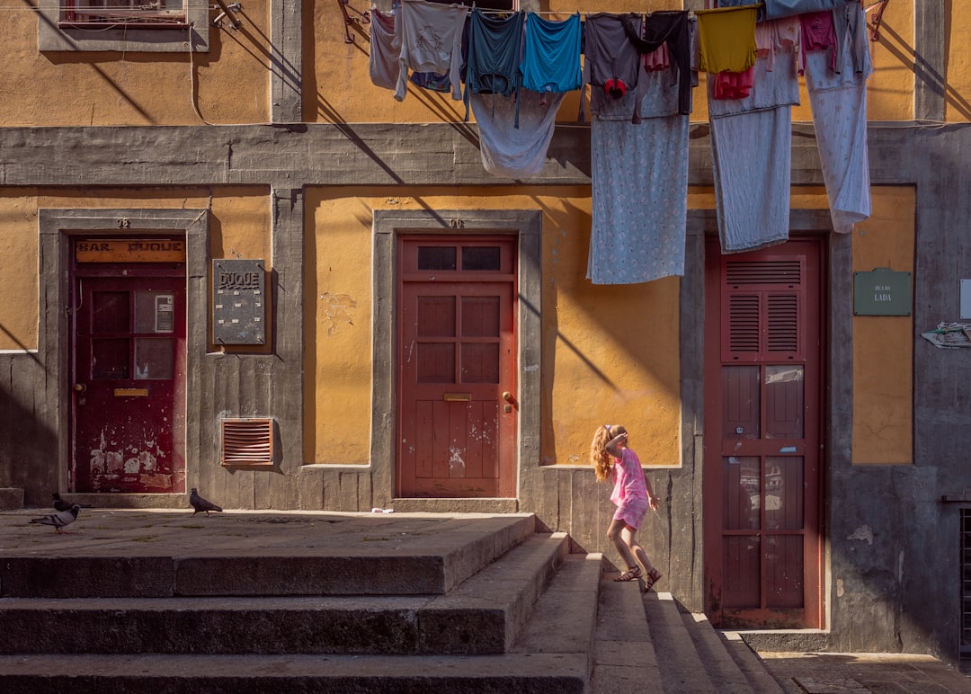 person walking on stairs beside brown door house, “Chihiro”