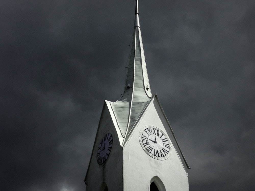 white concrete tower under gray clouds