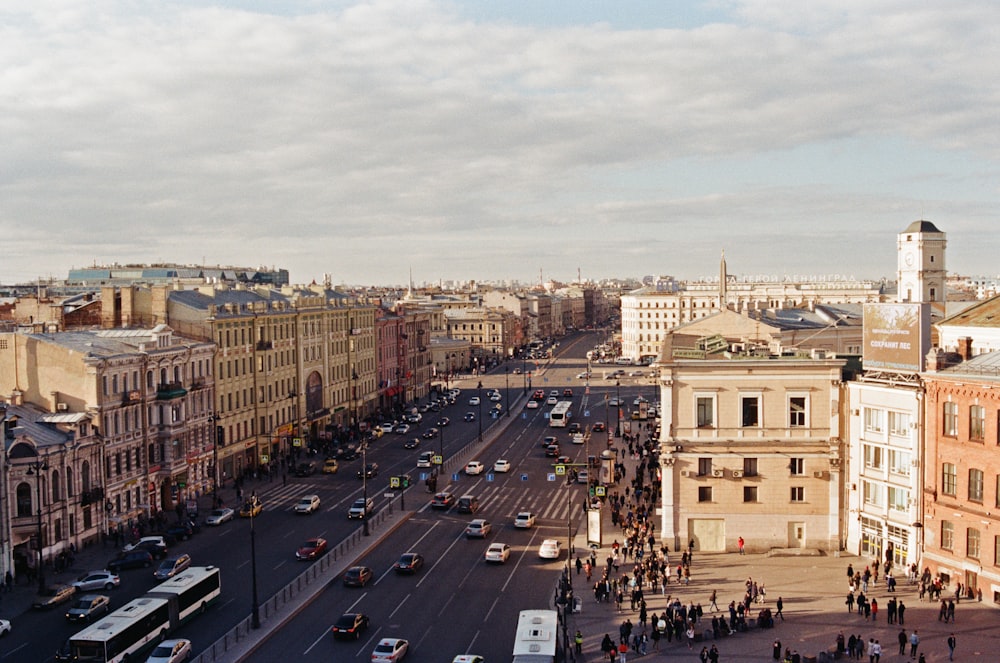 aerial photo of buildings and peoples with vehicles at daytime