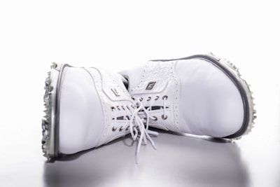 A display of stylish golf shoes and apparel hanging on a rack.