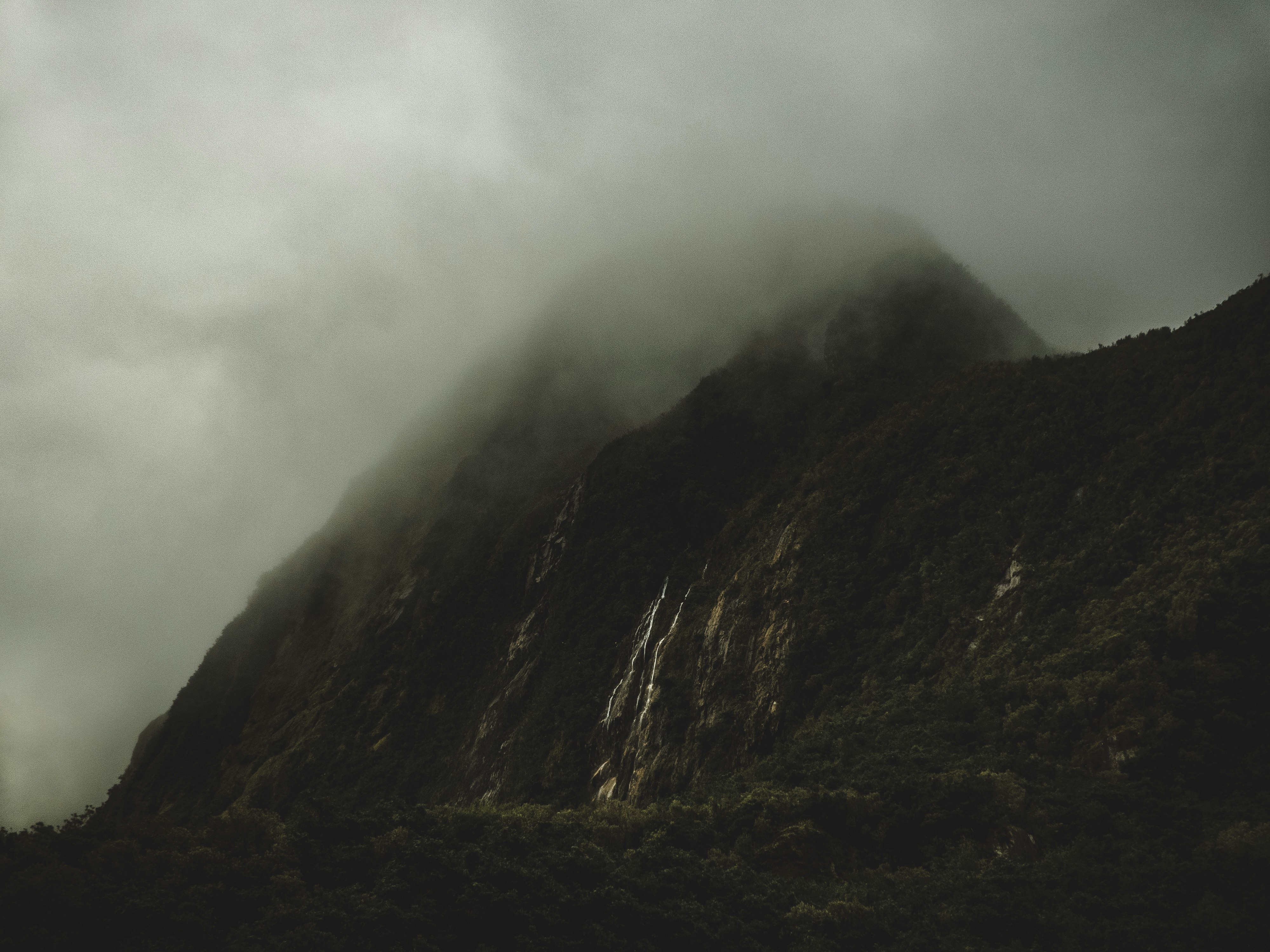 gray mountain covered by white clouds