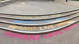 Colorful chalk messages on concrete steps convey sentiments like 'Humans teach here,' 'Humans study here,' 'Humans live here,' and 'Humans love here.' The steps are neatly aligned in a semi-circle pattern, with each message written in different colors.