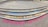 Colorful chalk messages on concrete steps convey sentiments like 'Humans teach here,' 'Humans study here,' 'Humans live here,' and 'Humans love here.' The steps are neatly aligned in a semi-circle pattern, with each message written in different colors.